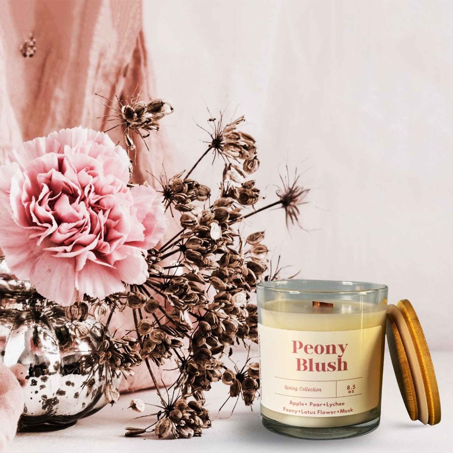 Peony Blush candle lit and radiating a sweet, floral scent.