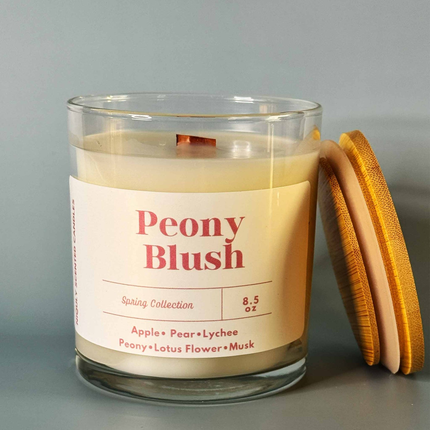 Peony Blush candle glowing with a soft floral fragrance.