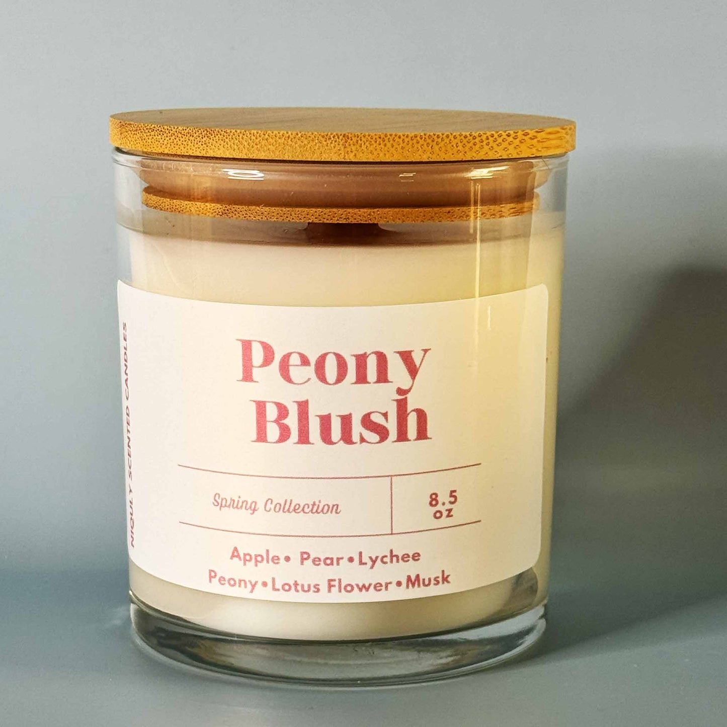 Aesthetic Peony Blush candle glowing in a cozy corner