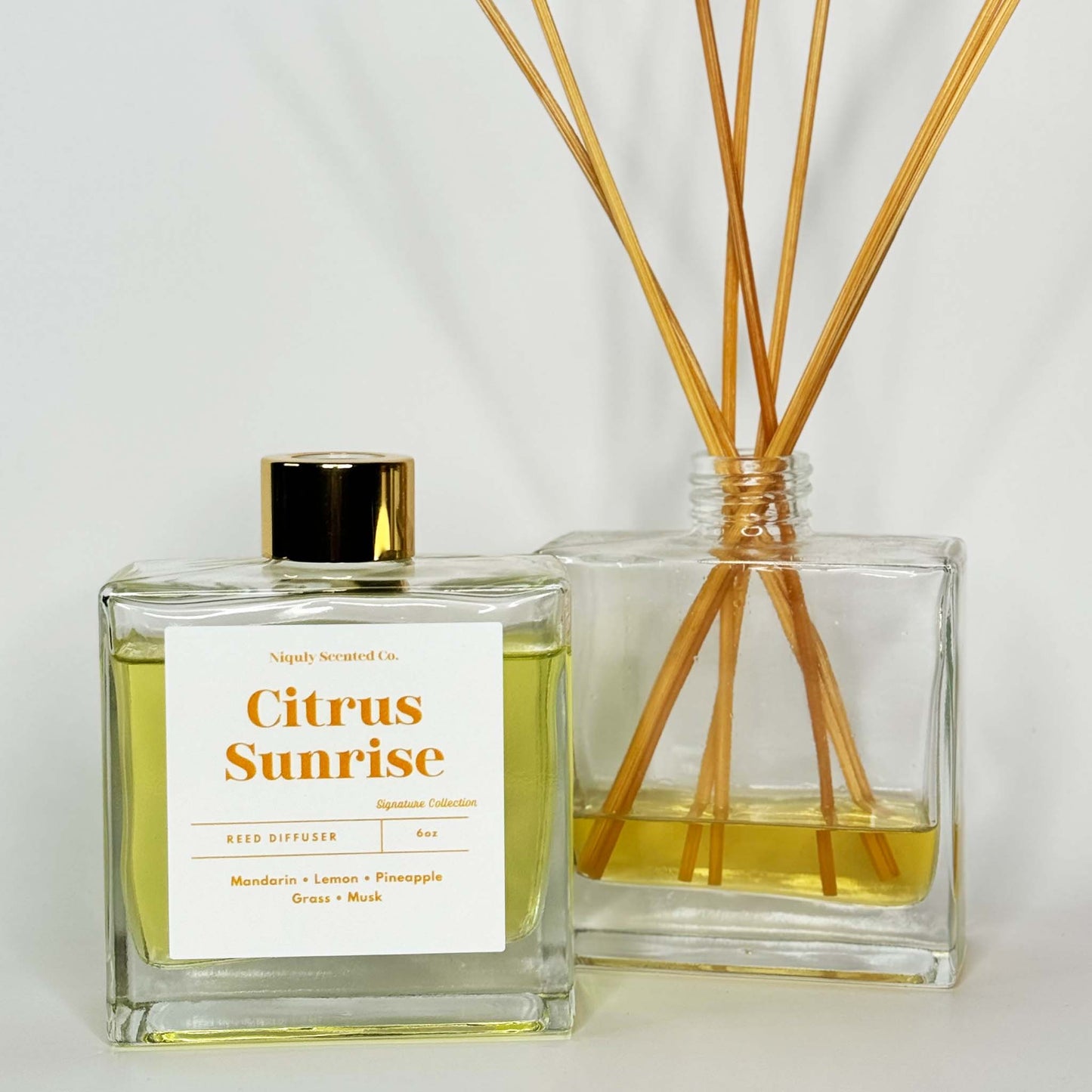 A vibrant Citrus Sunrise reed diffuser that fills the room with fresh, zesty citrus notes.