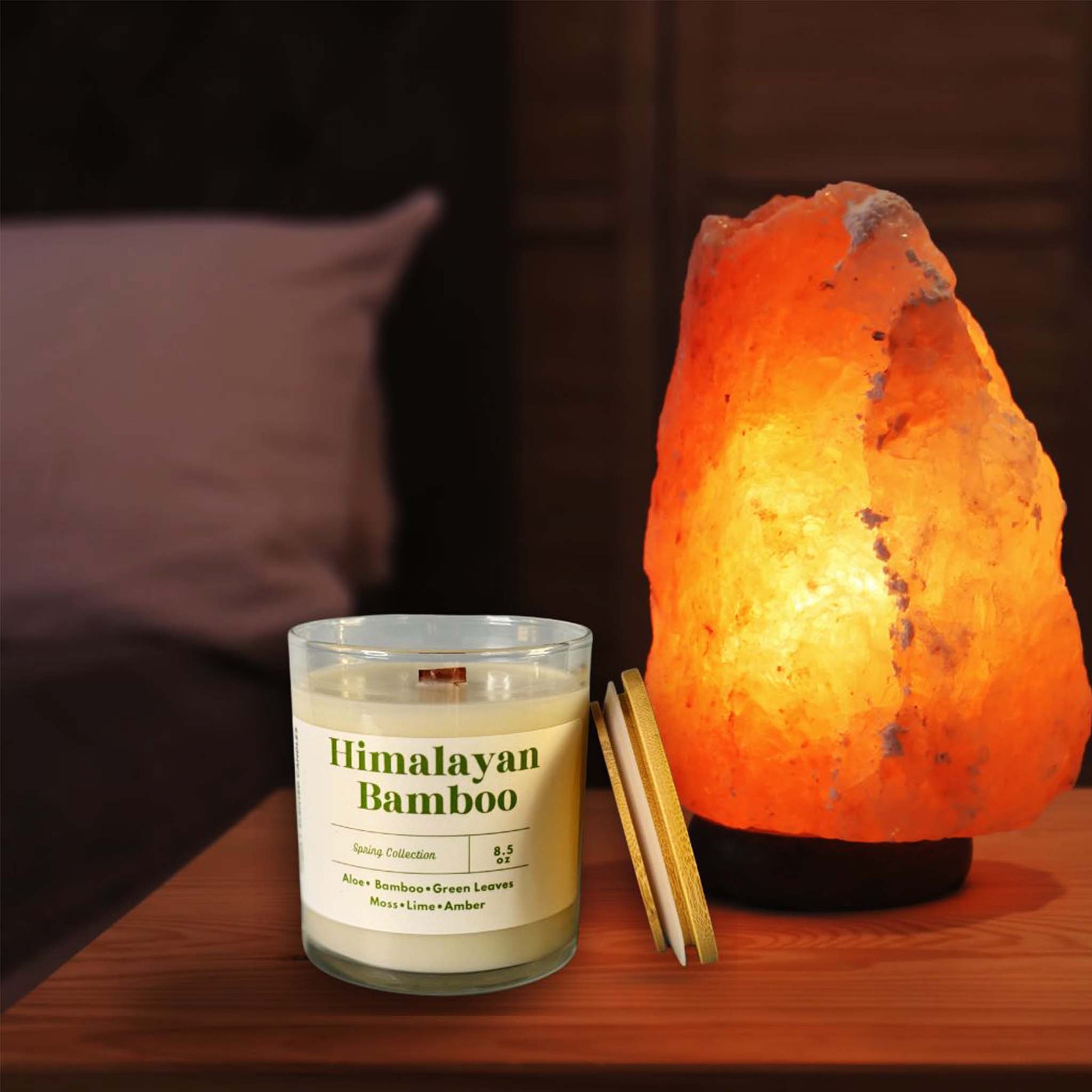 Himalayan Bamboo scented candle beside smooth stones and bamboo