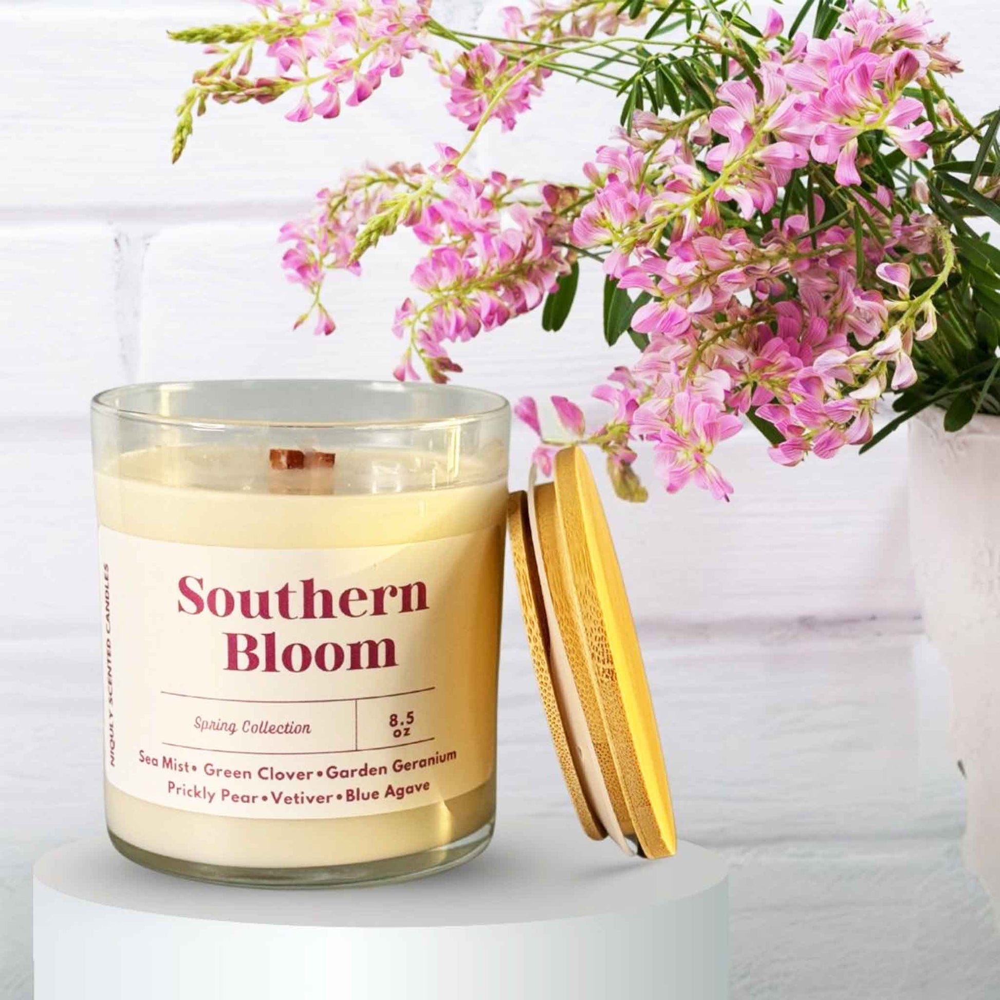 A lit Southern Bloom candle in a charming southern-style setting