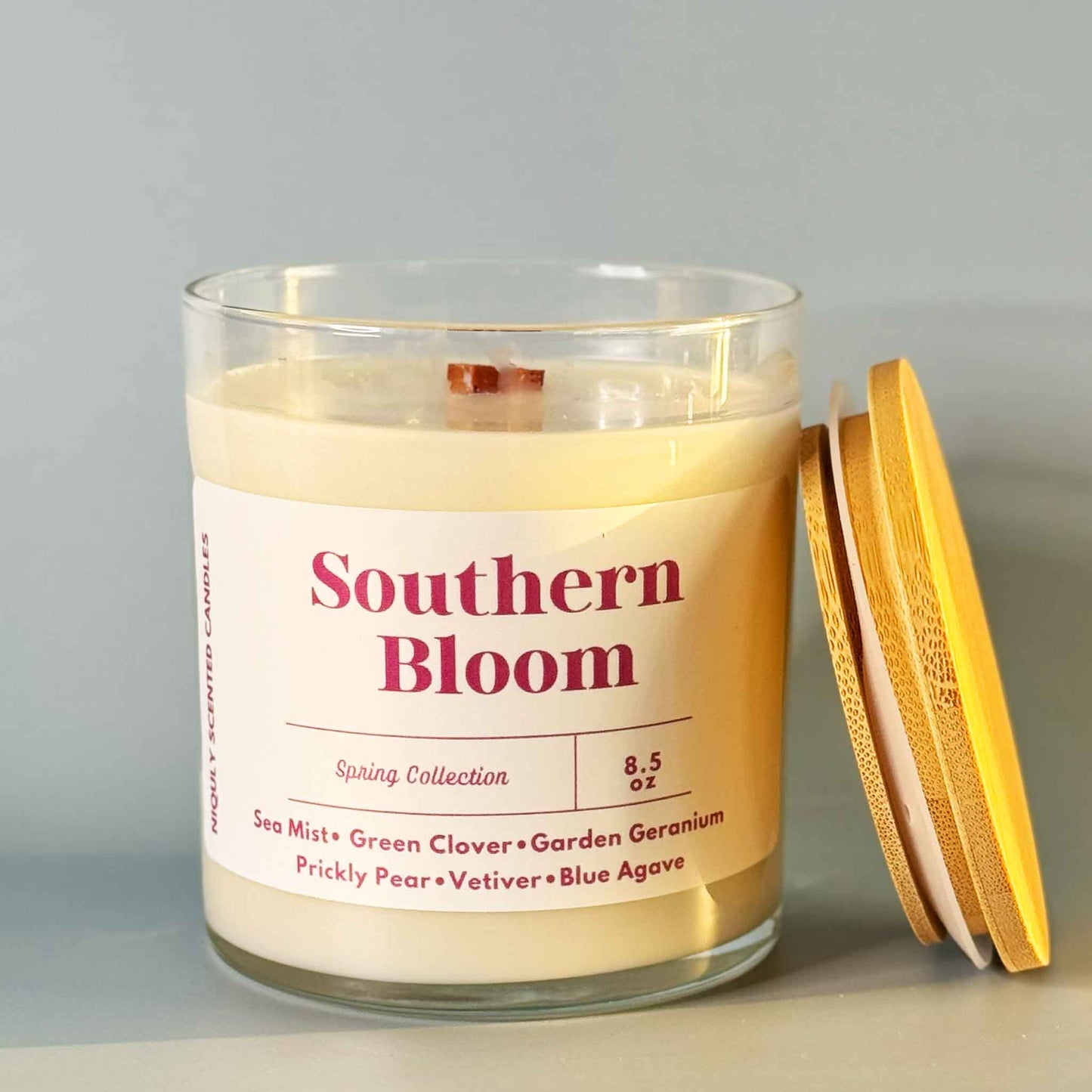 Southern Bloom candle glowing with a soft floral fragrance.