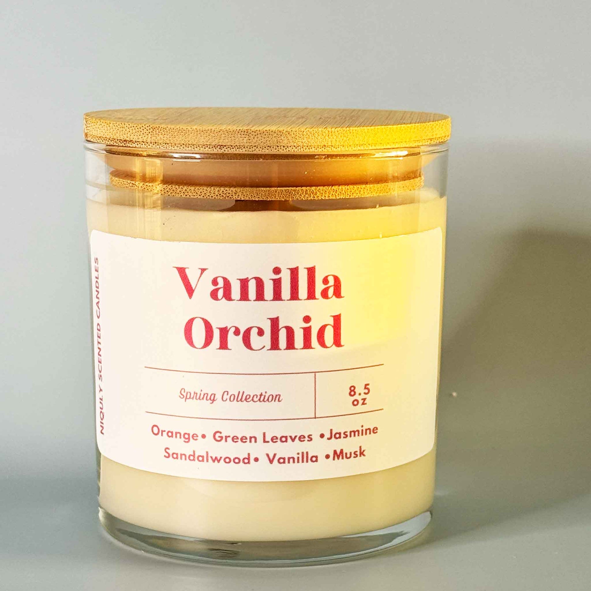 Softly flickering Vanilla Orchid candle in a minimalist jar.